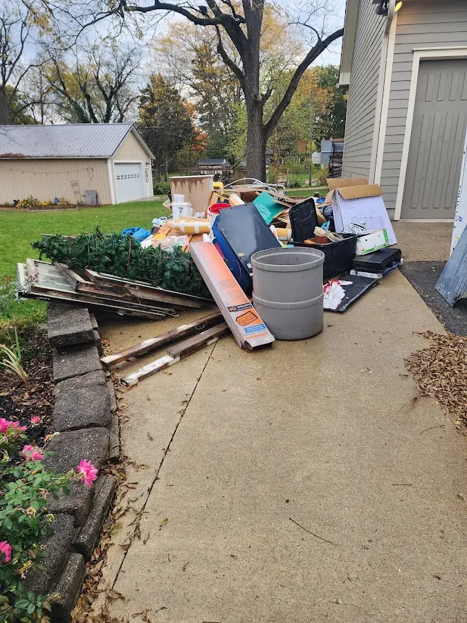 Dumpster being loaded with debris for Roofing Dumpster Rental in Turner